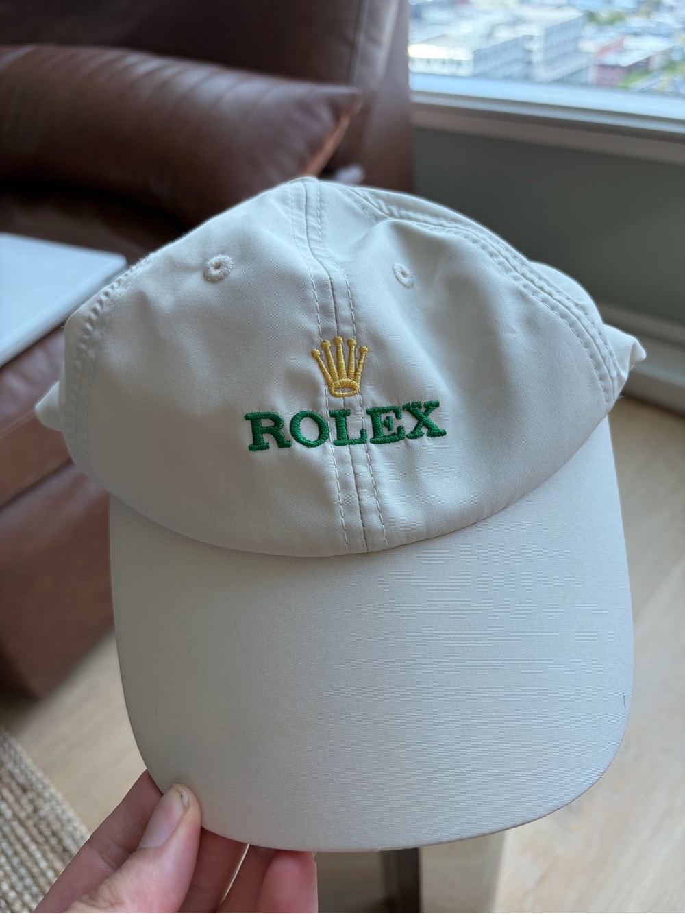 Rolex White Cap with Green and Gold Crown Accent